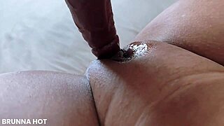 Sticking a dildo in my wet pussy on the bed first thing in morning