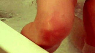 Petite girl shaves her smooth clit and pussy lips in bath wearing rubber gloves