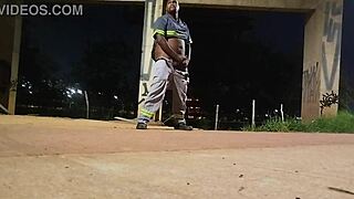 Uniformed figure pleasures self openly on the street