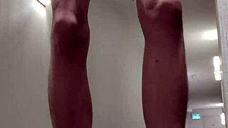 A solo boy indulges in self-pleasure while being nude in a hallway