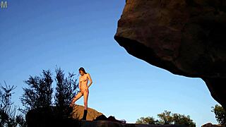 big tits stand on rock and plays