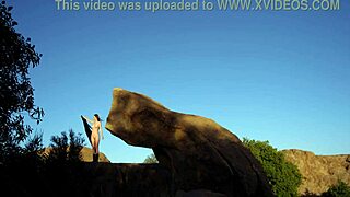 big tits stand on rock and plays