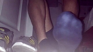 Blue sweaty socks and bare feet with a spill