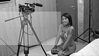 Backstage blowjob scene on a dark sofa