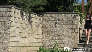 Petite brunette masturbates her shaved pussy in public outdoors