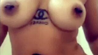 Mulatto woman indulges in solo pleasure in the bathtub, climaxing on herself