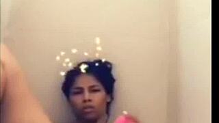 Mulatto woman indulges in solo pleasure in the bathtub, climaxing on herself