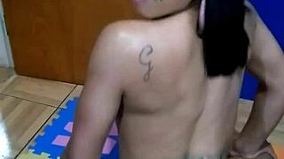 Tattooed Brunette Sits Sensually on Console Topless