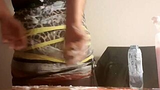 In this casual scene, a british slut gets sploshed in clingfilm, her ass wet and sloppy in fetish play.