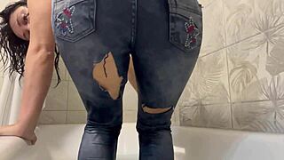 Solo babe indulges in fetish shower with wet clothes on