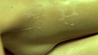 massaging babe jerks client's dick in the shower with close-up views of natural tits and handjob