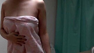 Young Japanese girl exposes natural tits in shower webcam