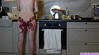 naked housewife with octopus tattoo cooking in kitchen