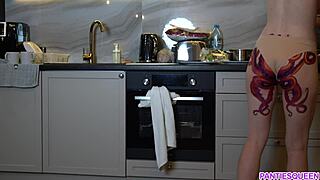 naked housewife with octopus tattoo cooking in kitchen