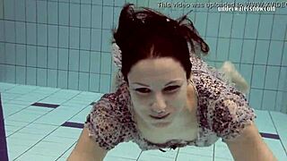 Loris Licicia swims naked underwater in pool.