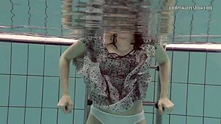 Loris Licicia swims naked underwater in pool.