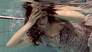 Loris Licicia swims naked underwater in pool.