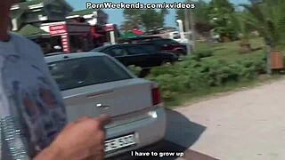 A brunette gives a blow job to a man on vacation