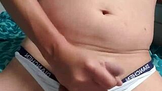 This gay boy is masturbating in his underwear, feeling so excited about it.