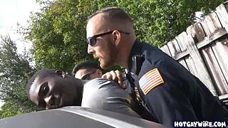 Two police officers in uniform take advantage of a black guy in the office for a hardcore interracial threesome