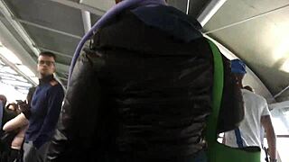 Touching the chubby girl's brown nylon jacket on the street, feeling the puffy material.