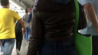 Touching the chubby girl's brown nylon jacket on the street, feeling the puffy material.