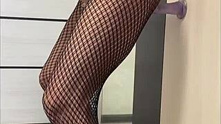 Fishnet clad MILF gets her legs and ass fucked with a dildo