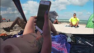 Married woman flaunts her shaved pussy at a public beach