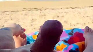 teasing him to finish on a public beach