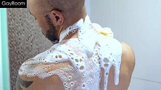 A slender young man uses his large penis to have anal sex with another man in the shower