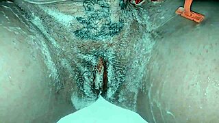 milf casually shaving her trimmed pussy up close with lots of soap