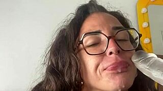 tattooed brunette in lingerie and glasses plays with her toys solo