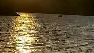 Showing off her bare pussy at the beach without panties