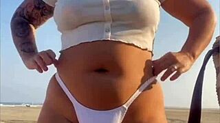 swollen pussy flashing on beach with muscular redhead exhibitionist