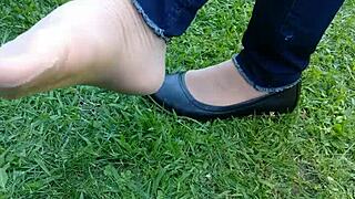 she teases with shoeplay, dipping tan nylons and flats in a fetish scene