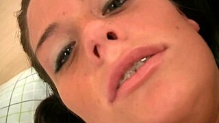 Dark-haired slut fingers her tight pussy.