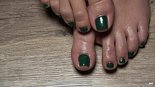 a close up of my toes with green nails for your fetish