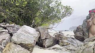 monika fox swims in the sea and plays with a toy on white sand beach