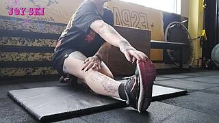 I'm the alternative girl streching at the gym, all tatooed