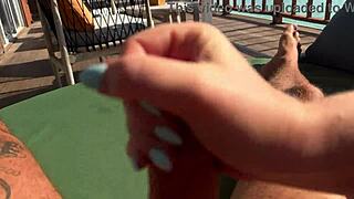 Hot milf gives a fast handjob on the ocean terrace