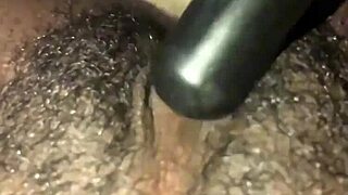 ebony woman plays with her wet hairy pussy solo