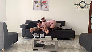 Friend helps with college homework in dorm room study session.