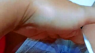 Pretty girl fingers pink pussy in office