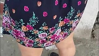 Following a mature woman in a skirt and thong on the street