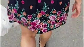 Following a mature woman in a skirt and thong on the street