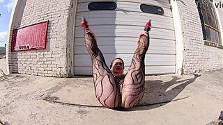 that thong bodysuit is worn by the brunette while walking the docks in the public outdoor setting