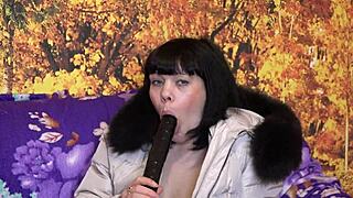 milf in a down coat with fur trim sucks big dildo in various positions, amateur fetish