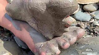 goddess teases messy torn pantyhose feet closeup by riverbank outdoors