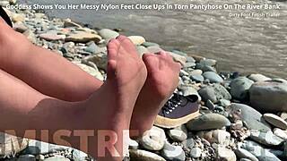 goddess teases messy torn pantyhose feet closeup by riverbank outdoors