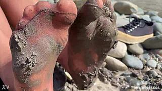goddess teases messy torn pantyhose feet closeup by riverbank outdoors